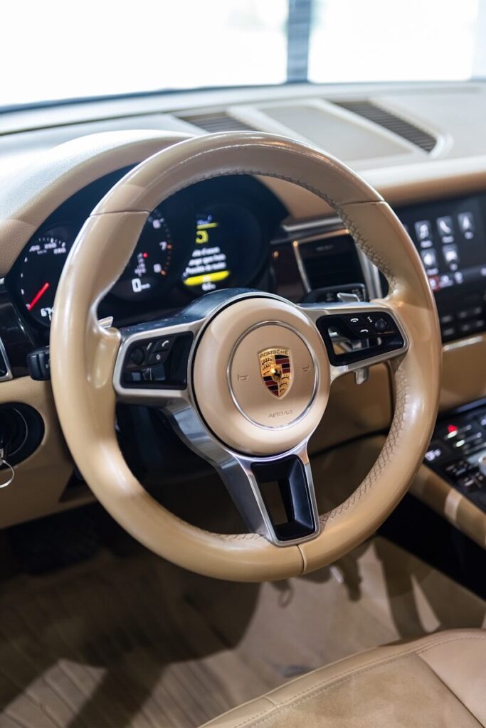 the interior of a car with a steering wheel and dashboard